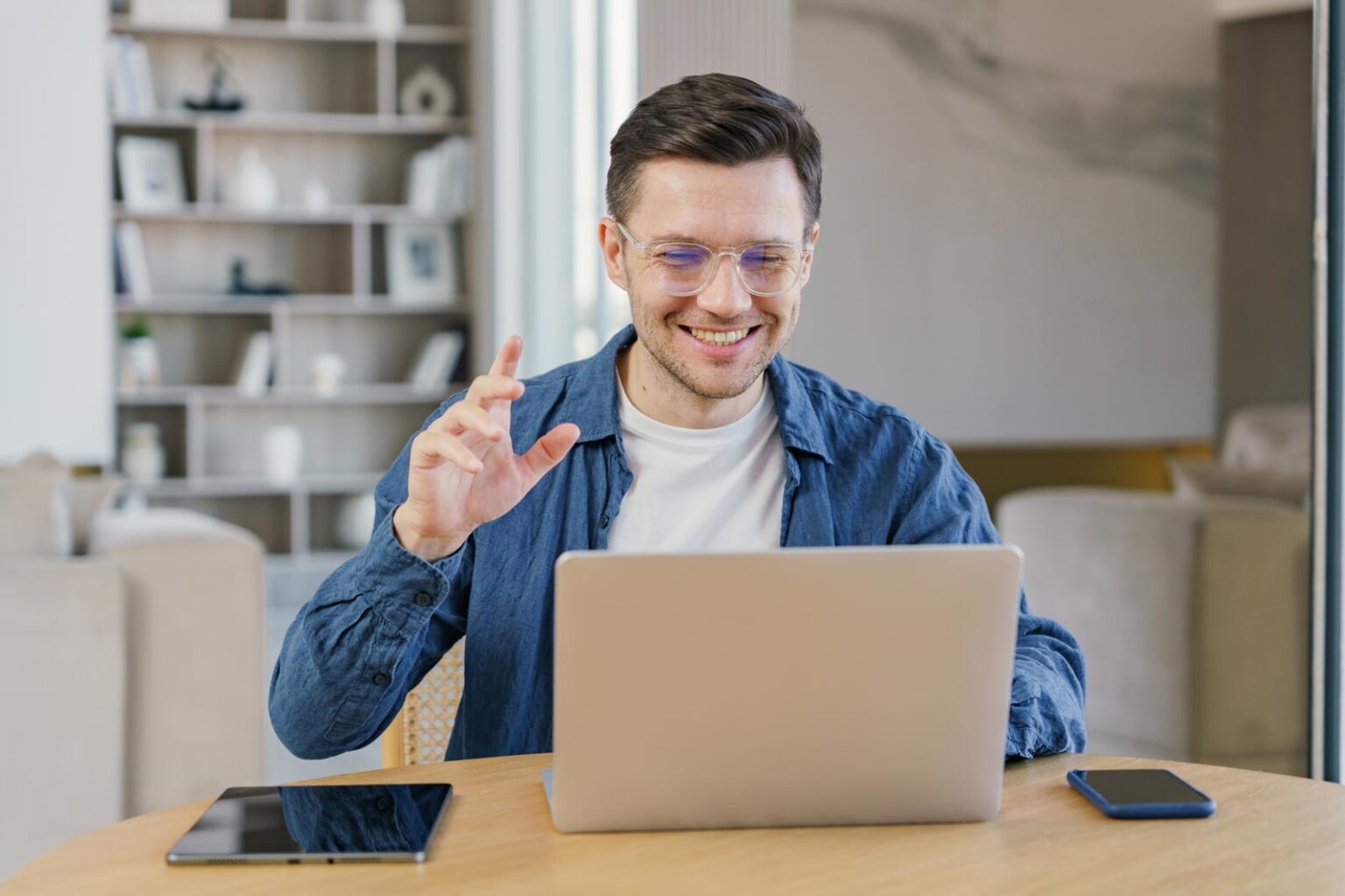 Happy man communicating by a video call